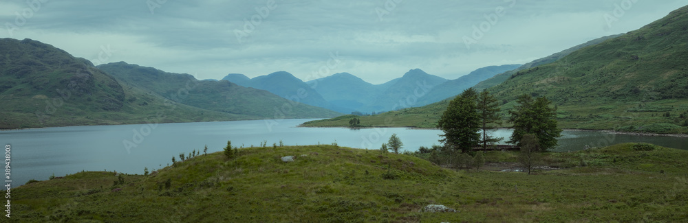 Scottish landscape with a mountain lake and trees. Loch Arklet, Highlands, Scotland