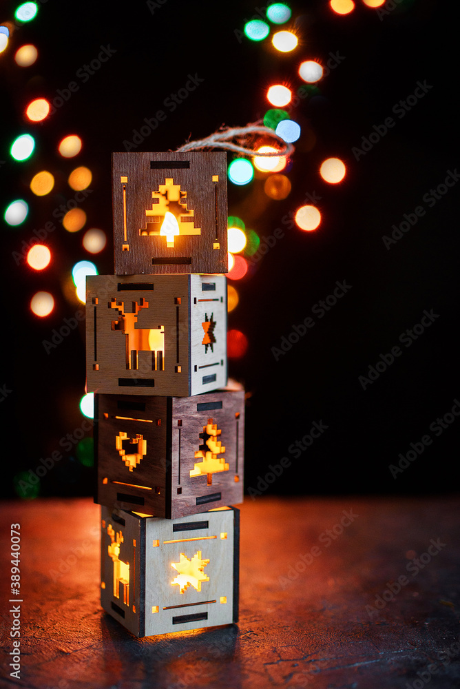Beautiful Christmas tree lanterns and houses. New Year's side, candle with fire. Eco souvenirs.