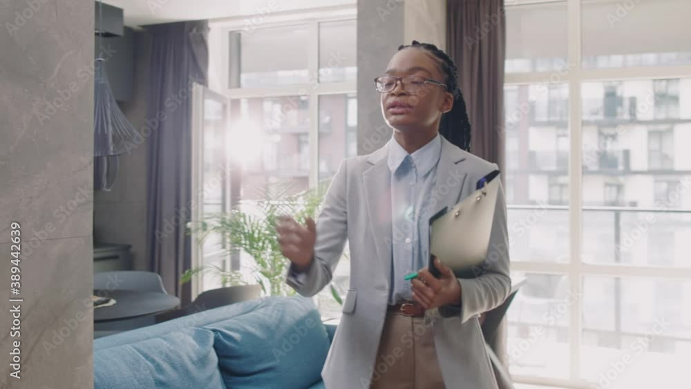 Unhappy family couple dissatisfied with house offer leaving the realtor. Frustrated african young woman housing agent sitting down in despair. Failure. Real estate concept. Unhappy family couple dissatisfied with house offer leaving the realtor. Frustrated african young woman housing agent sitting down in despair. Failure. Real estate concept.