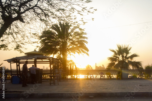 Sunset in Cairo - Riverside pedestrian path and silhouettes - Cairo, Egypt photo