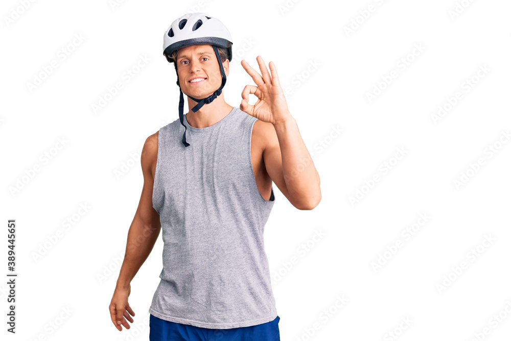 Young handsome man wearing bike helmet smiling positive doing ok sign with hand and fingers. successful expression. Young handsome man wearing bike helmet smiling positive doing ok sign with hand and fingers. successful expression.