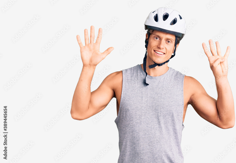 Young handsome man wearing bike helmet showing and pointing up with fingers number nine while smiling confident and happy. Young handsome man wearing bike helmet showing and pointing up with fingers number nine while smiling confident and happy.
