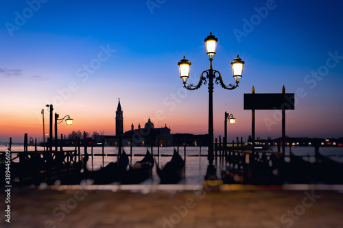 Obraz na płótnie Morning view of the embankment in Venice, Italy. Gondolas parked off the coast. Colorful landscape, long exposure, tilt-shift effect. w salonie