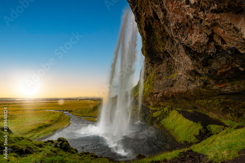 View through the Seljalandsfoss waterfall in Iceland at sunset