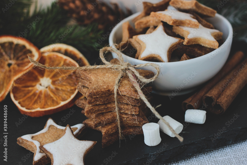 Cute Christmas composition with cookies in basket, marshmallow and dried orange Cute Christmas composition with cookies in basket, marshmallow and dried orange