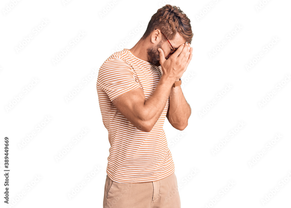 Young caucasian man wearing casual clothes and glasses with sad expression covering face with hands while crying. depression concept. Young caucasian man wearing casual clothes and glasses with sad expression covering face with hands while crying. depression concept.
