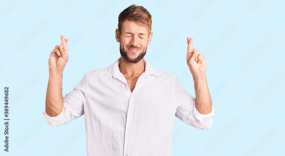 Young caucasian man wearing casual clothes gesturing finger crossed smiling with hope and eyes closed. luck and superstitious concept. Young caucasian man wearing casual clothes gesturing finger crossed smiling with hope and eyes closed. luck and superstitious concept.