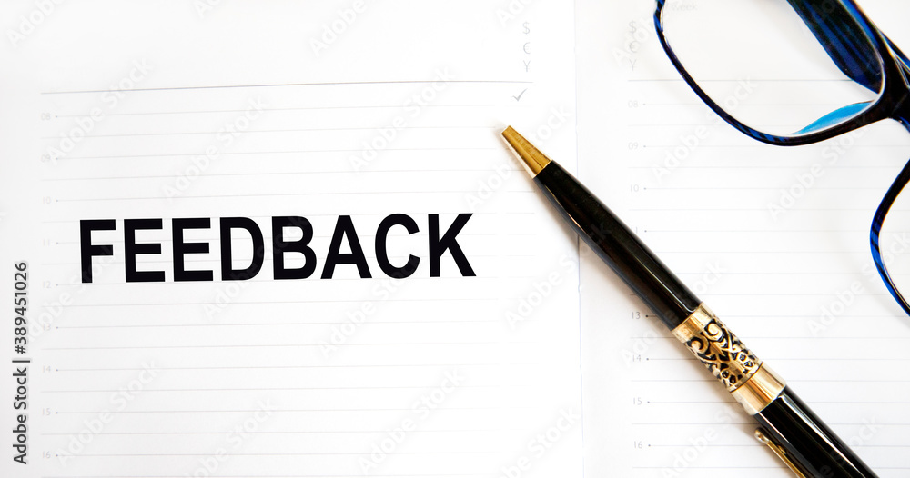 On the brush with the diary text FEEDBACK, next to glasses, pencil. On the brush with the diary text FEEDBACK, next to glasses, pencil.