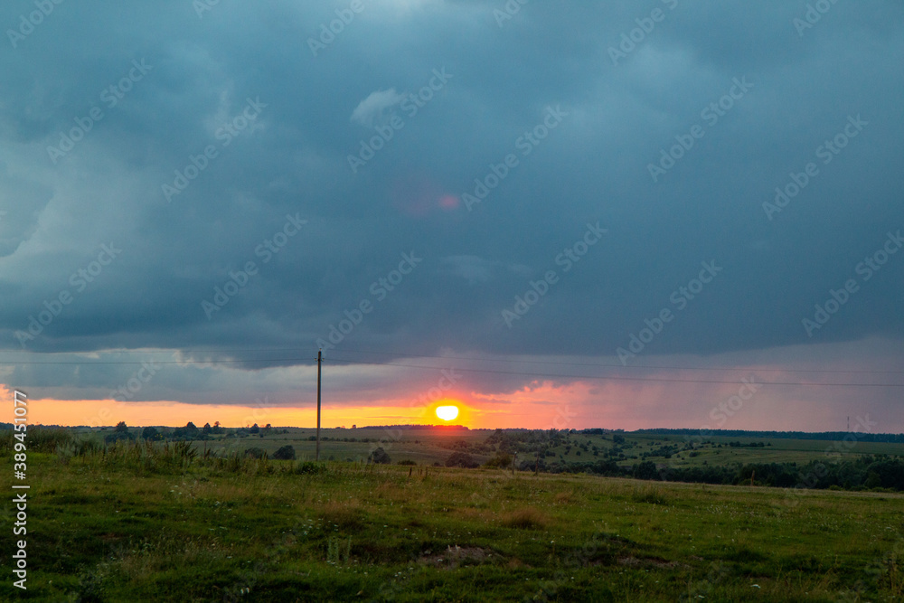 sunset on the horizon in the field and clouds sunset on the horizon in the field and clouds