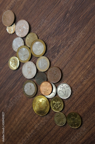 Coins on the table  top view. Wooden background.