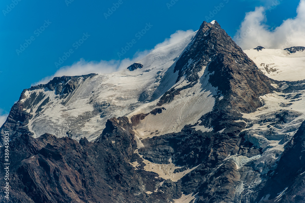 Alpine mountain peak Jegihorn 3206m, Tälli glacier (Tälligletscher) and moraine, Fletschhorn 3996m (center) above Kreuzboden cablecar station (2400m) that goes from Saas-Gruund to Hohsaas, Valais,