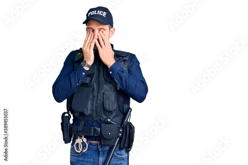 Cuadro en lienzo Young handsome man wearing police uniform rubbing eyes for fatigue and headache, sleepy and tired expression