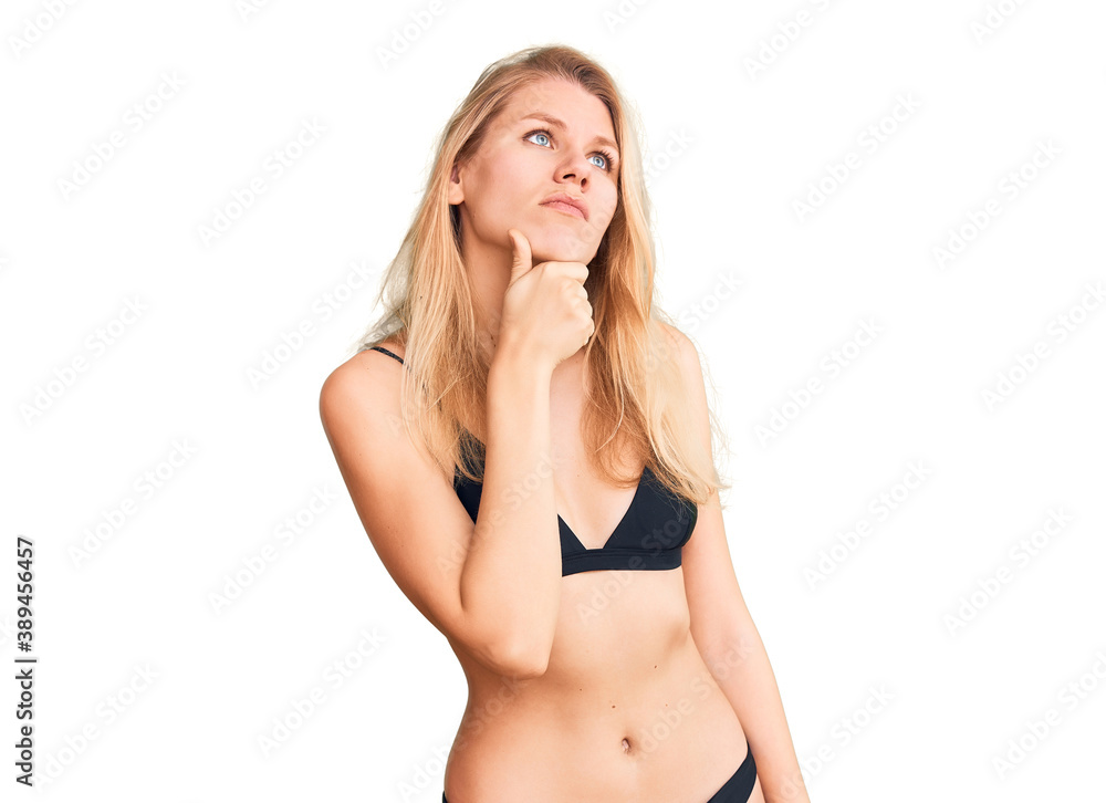 Fototapeta premium Young beautiful blonde woman wearing bikini touching painful neck, sore throat for flu, clod and infection