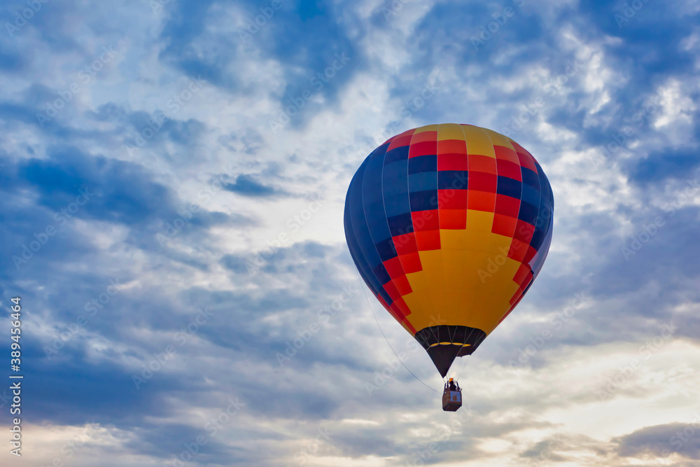 Blue red yellow balloon against cloudy sky Blue red yellow balloon against cloudy sky