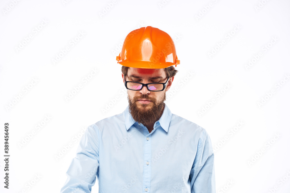 A man in orange paint in glasses documents a manual industry A man in orange paint in glasses documents a manual industry