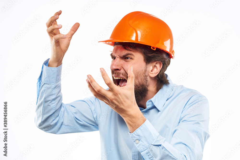 Angry man in orange hard hat industry work dissatisfaction cropped view Angry man in orange hard hat industry work dissatisfaction cropped view