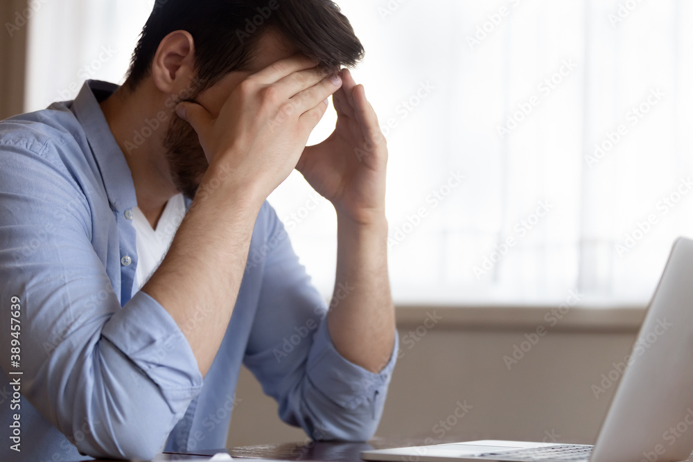 I cannot give more. Exhausted fatigue young male employee freelancer working from home sitting at workplace by laptop screen tired from work feeling headache migraine pain stress depression burnout I cannot give more. Exhausted fatigue young male employee freelancer working from home sitting at workplace by laptop screen tired from work feeling headache migraine pain stress depression burnout