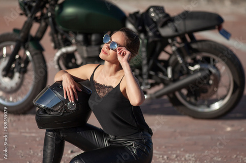 Fototapeta woman in black with a motorcycle