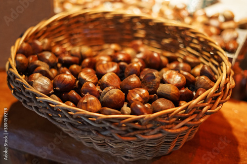 Edible roasted chestnuts in wicker basket is traditional winter Christmas food