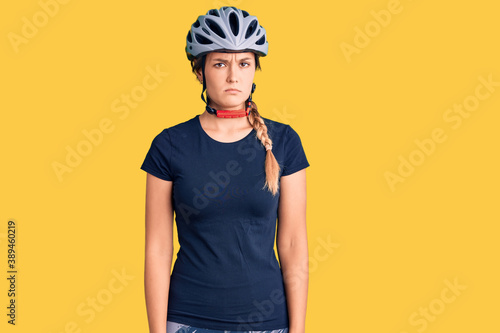 Beautiful caucasian woman wearing bike helmet skeptic and nervous, frowning upset because of problem. negative person.
