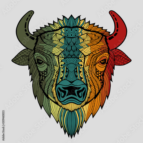 Patterned colorful head of a bull, bison. Abstract ethnic image of the head of a buffalo with an unusual ornament. Colorful rainbow decoration painted by hand. Series of animals in the ethnic style.