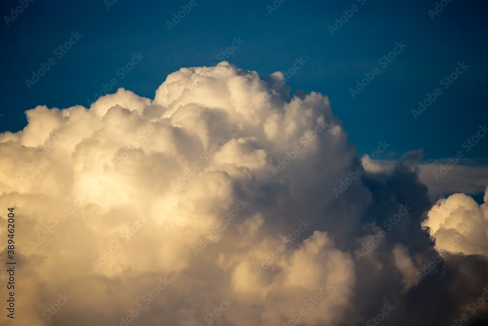 Cumulus clouds in the sunset light. Abstract composition of dramatic sky.