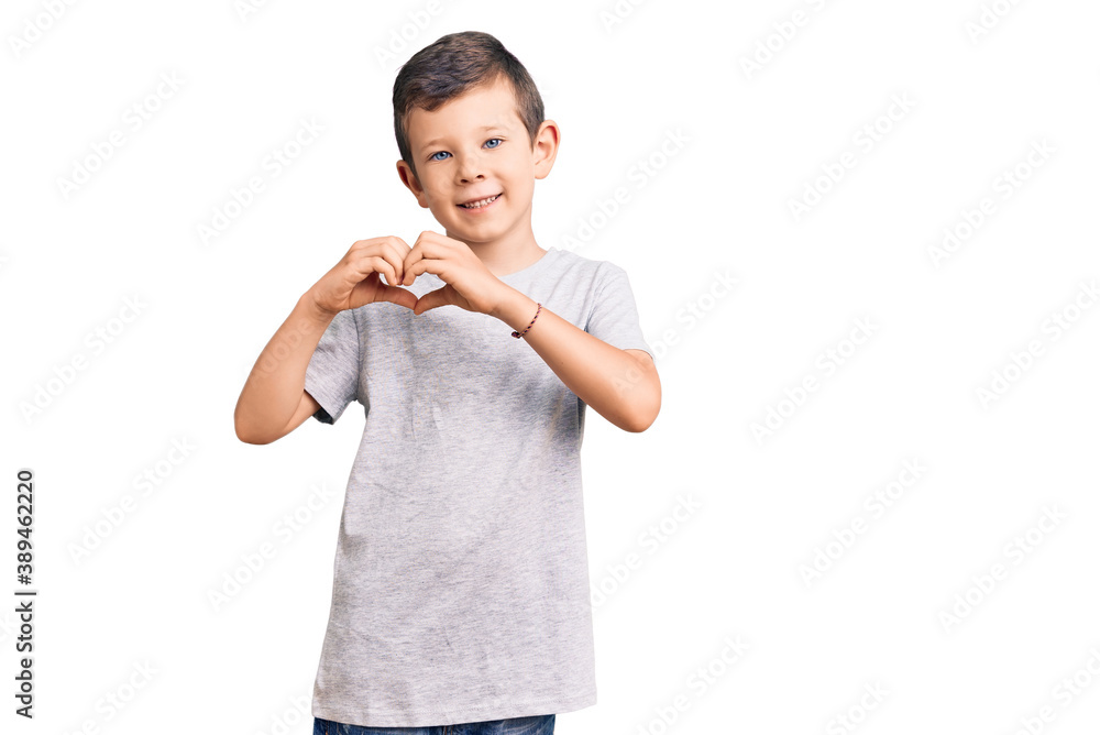 Cute blond kid wearing casual clothes smiling in love showing heart symbol and shape with hands. romantic concept.