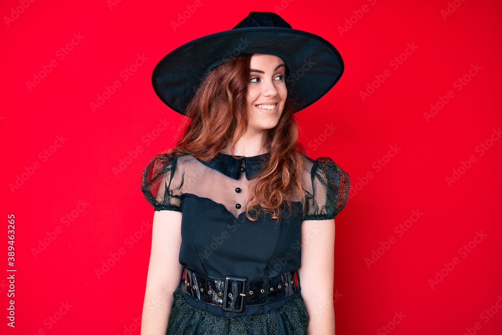 Young beautiful woman wearing witch halloween costume looking to side, relax profile pose with natural face and confident smile. Young beautiful woman wearing witch halloween costume looking to side, relax profile pose with natural face and confident smile.
