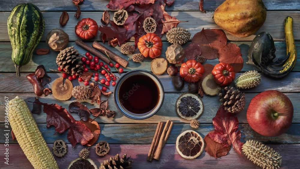 Autumn background. Cup of tea on wooden table with colorful vegetables, pumpkins, autumn harvest, leaves. Loop stop motion. Autumn background. Cup of tea on wooden table with colorful vegetables, pumpkins, autumn harvest, leaves. Loop stop motion.