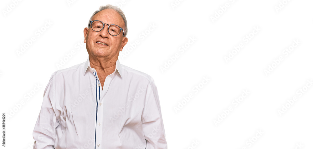 Senior caucasian man wearing business shirt and glasses relaxed with serious expression on face. simple and natural looking at the camera. Senior caucasian man wearing business shirt and glasses relaxed with serious expression on face. simple and natural looking at the camera.