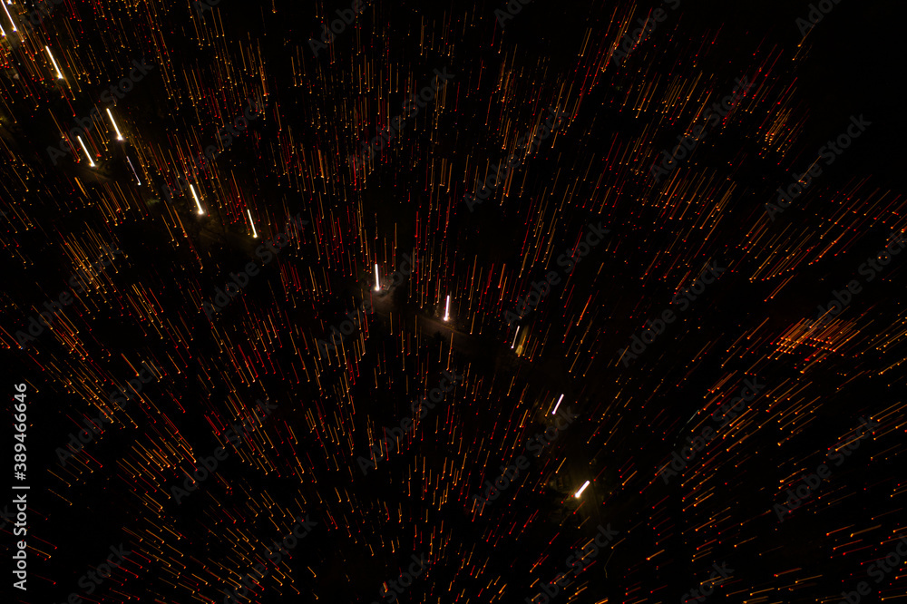Fototapeta premium Motion abstract lines or particles on black background. candle light, fireworks