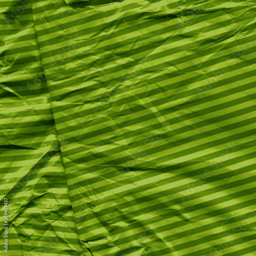 Green vintage and old looking crumpled paper background. Retro cardboard texture. Grunge paper for drawing. Ancient book page. Present wrapping.