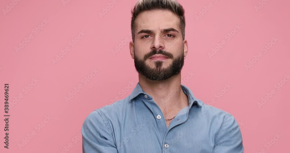 handsome casual guy dancing, pointing finger, gesturing call me, crazy, the finger gun and being clueless on pink background handsome casual guy dancing, pointing finger, gesturing call me, crazy, the finger gun and being clueless on pink background