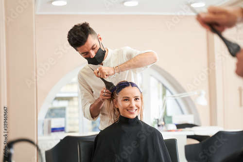 Hairdresser applying dye on clients hair photo