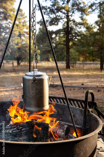 Making coffee over a camp fire in the woods while camping