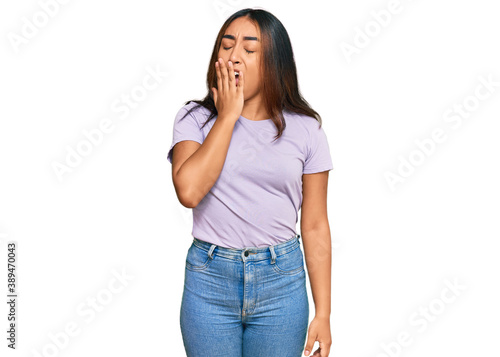 Young latin woman wearing casual clothes bored yawning tired covering mouth with hand. restless and sleepiness.