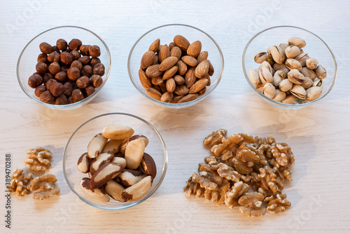 several different types of nuts are in cups