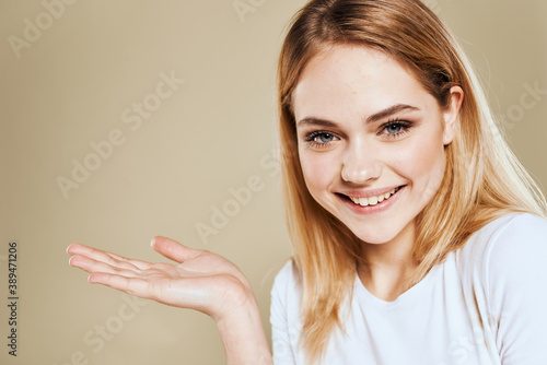 Wallpaper Mural Cheerful blonde gesturing with her hands studio beige background Torontodigital.ca