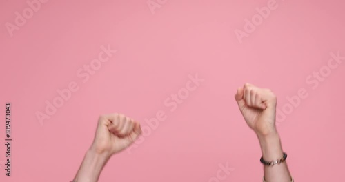 two hands showing palms, giving a thumbs up, celebrating succes, clapping on pink background photo