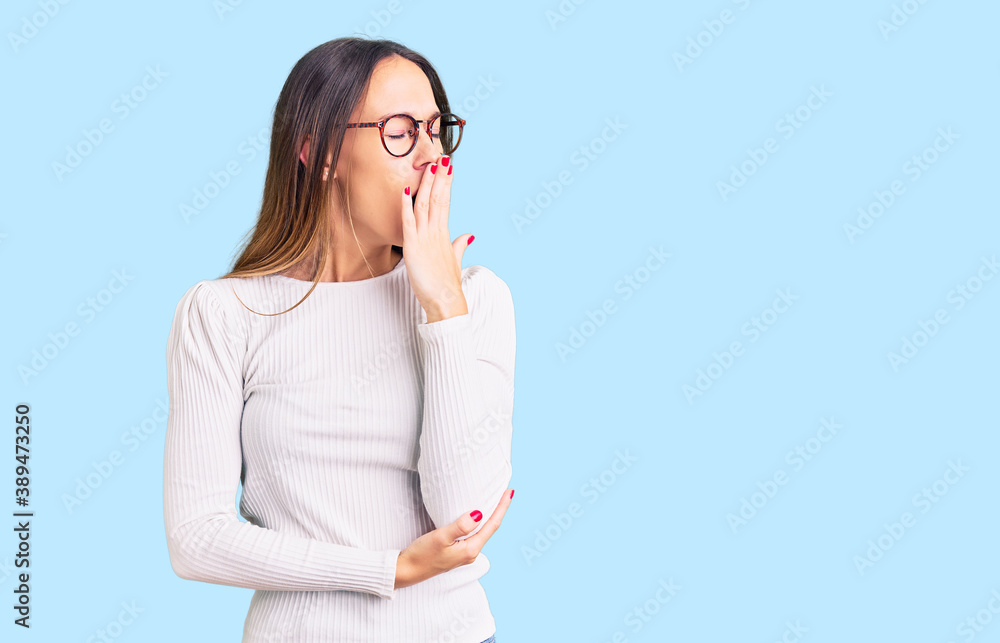 Beautiful brunette young woman wearing casual white sweater and glasses bored yawning tired covering mouth with hand. restless and sleepiness. Beautiful brunette young woman wearing casual white sweater and glasses bored yawning tired covering mouth with hand. restless and sleepiness.