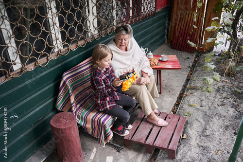 Granny and kid playing together near the home