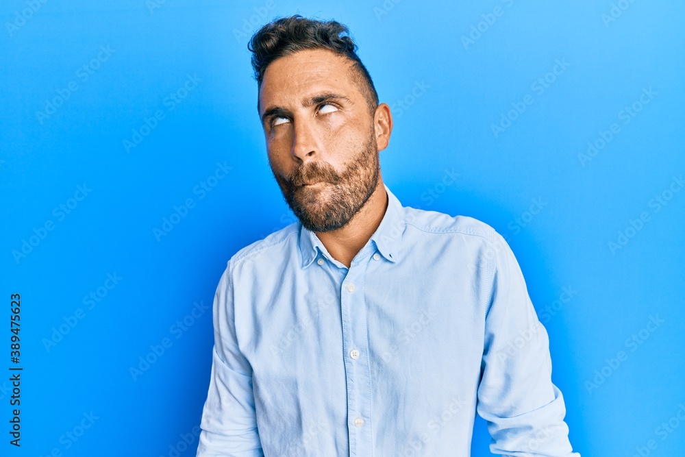 Handsome man with beard wearing casual clothes making fish face with lips, crazy and comical gesture. funny expression. Handsome man with beard wearing casual clothes making fish face with lips, crazy and comical gesture. funny expression.
