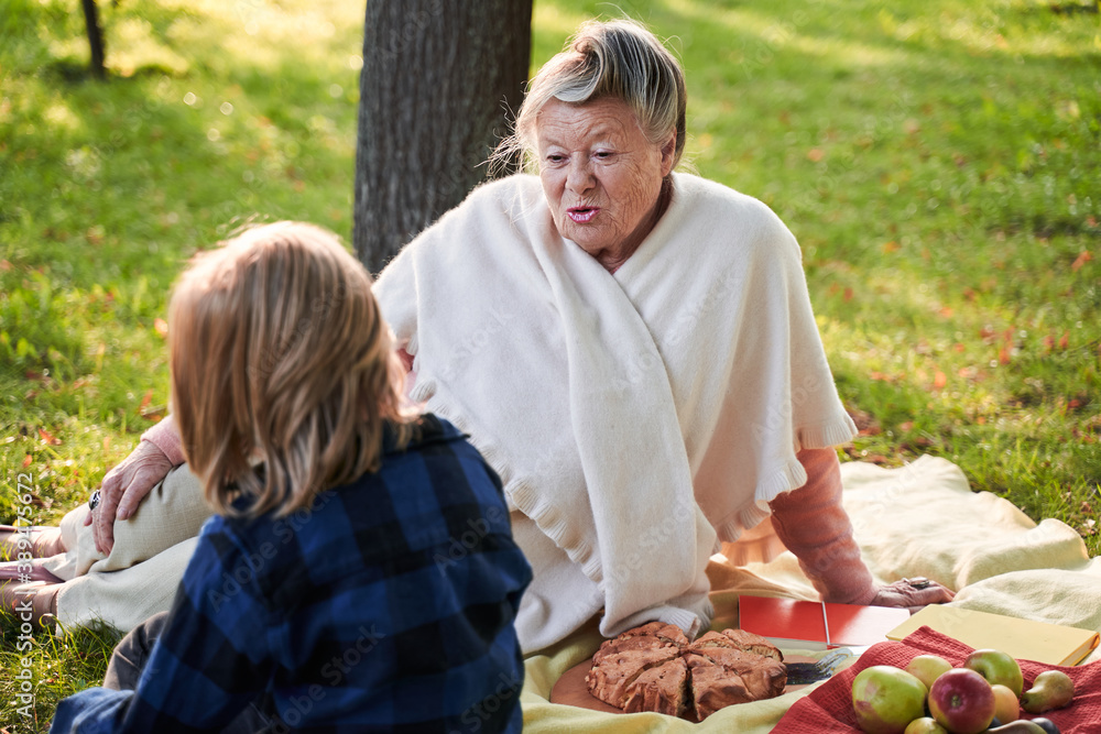 Woman speaking with grandchild at the picnic Woman speaking with grandchild at the picnic