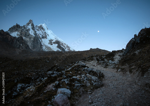 Fototapeta Salkantay Mountain with moon at backdrop with Salkantay trail landscape