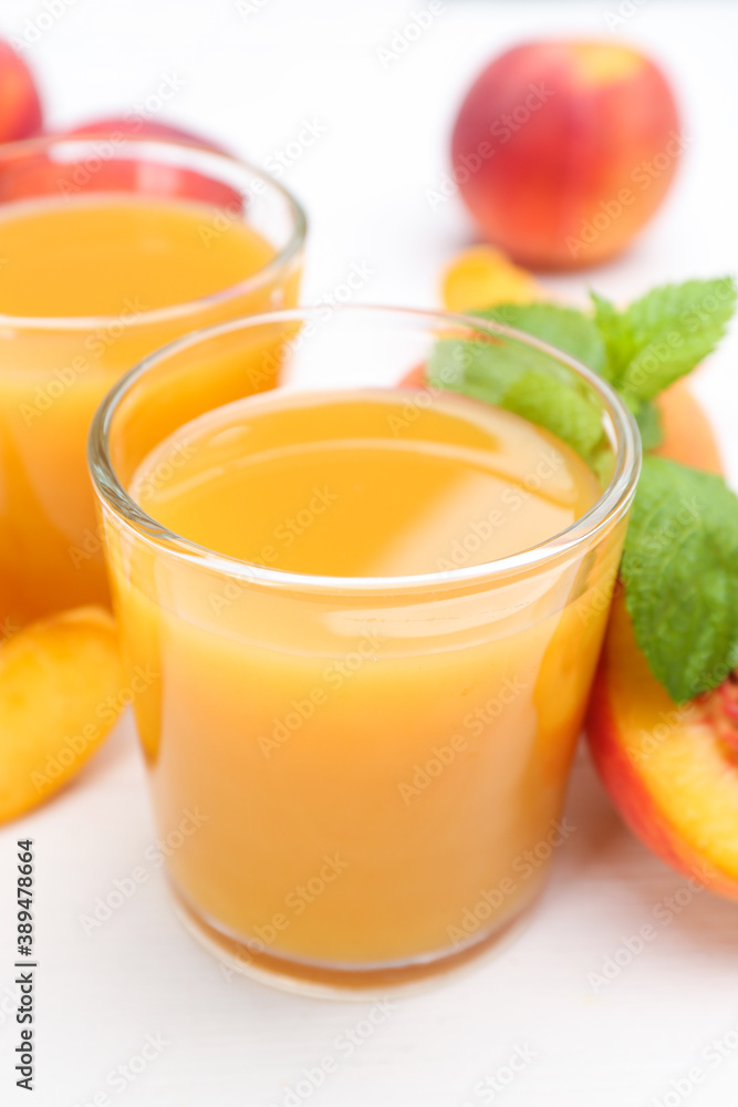 Natural peach juice and fresh fruits on white wooden table, closeup Natural peach juice and fresh fruits on white wooden table, closeup
