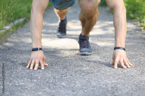 Person holding hands on asphalt