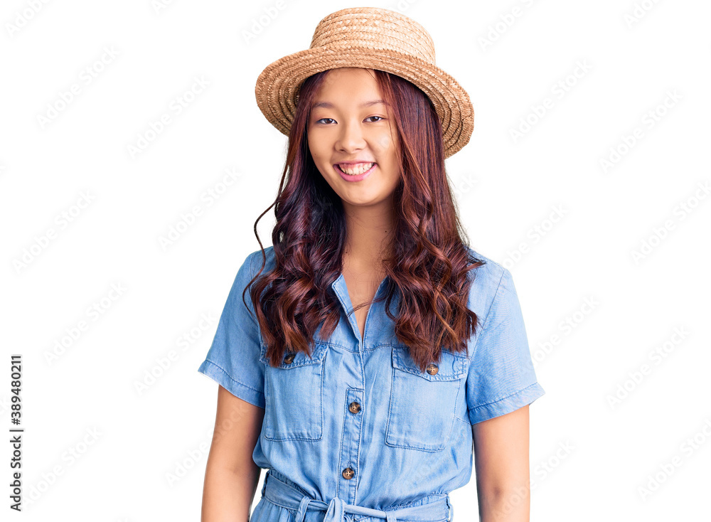 Young beautiful chinese girl wearing summer hat with a happy and cool smile on face. lucky person. Young beautiful chinese girl wearing summer hat with a happy and cool smile on face. lucky person.