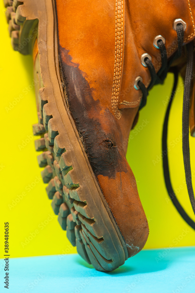 A ruined shoe. Cracks and stains on the surface of the shoe.