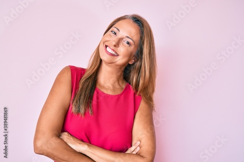 Middle age hispanic woman wearing casual clothes happy face smiling with crossed arms looking at the camera. positive person.