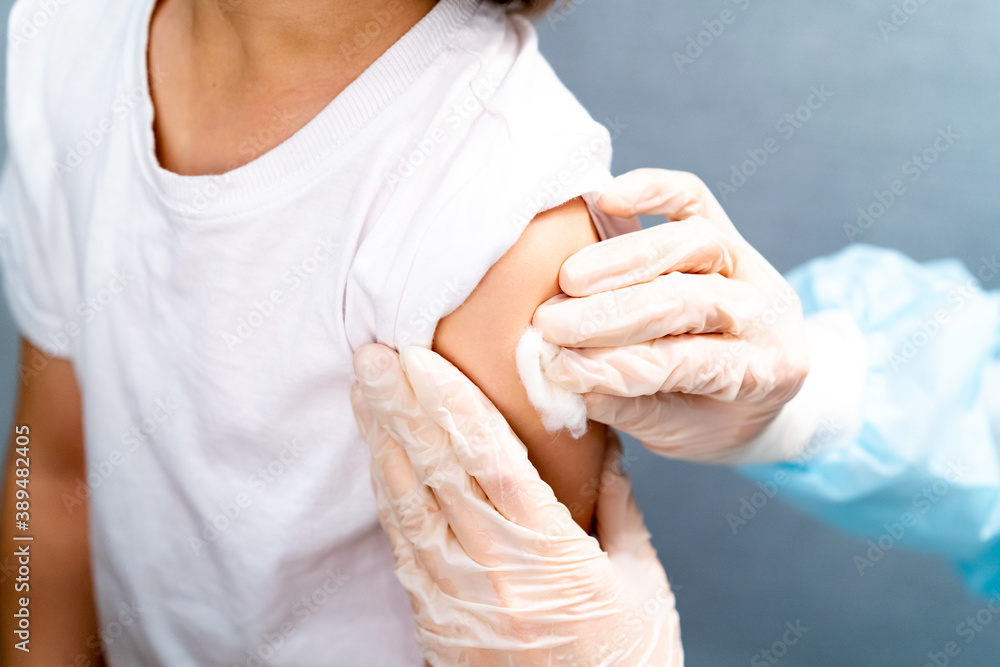Doctor vaccinating child. Coronavirus vaccination. Covid-19 vaccine at clinic. Little boy getting flu shot. Pediatrician examining kid and giving injection. Virus prevention. Health care. Doctor vaccinating child. Coronavirus vaccination. Covid-19 vaccine at clinic. Little boy getting flu shot. Pediatrician examining kid and giving injection. Virus prevention. Health care.